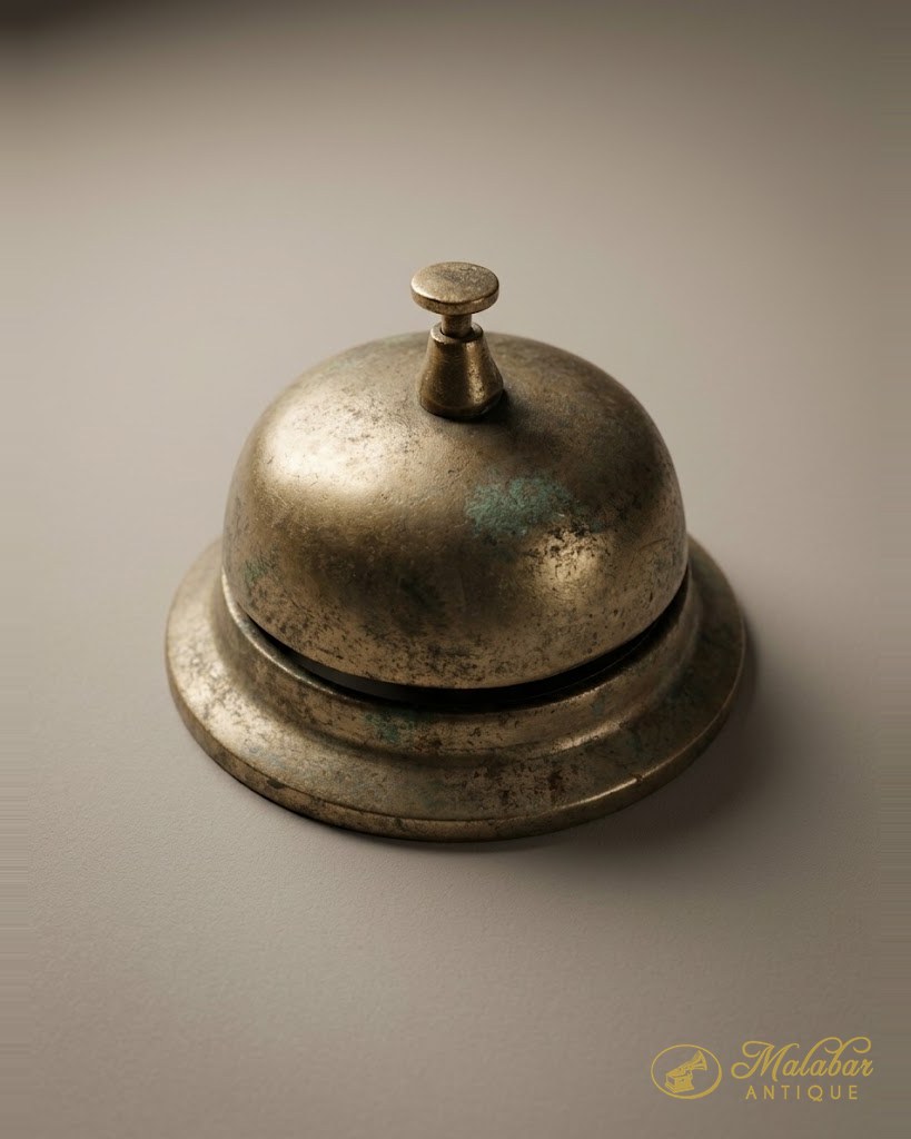 Domed brass counter bell with a turned press knob.