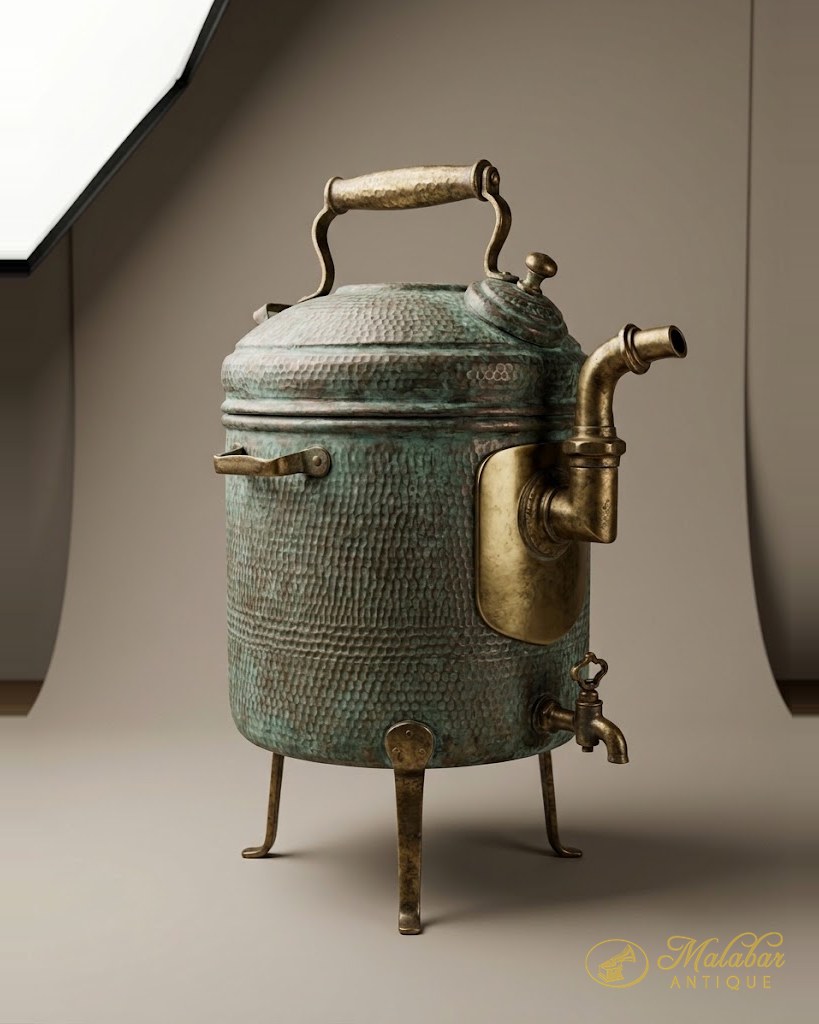 Hammered copper urn with a brass tap and handles, on three cast legs.