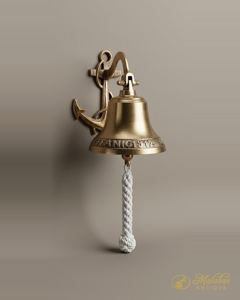 Brass bell with a rope lanyard, mounted on a cast anchor bracket.
