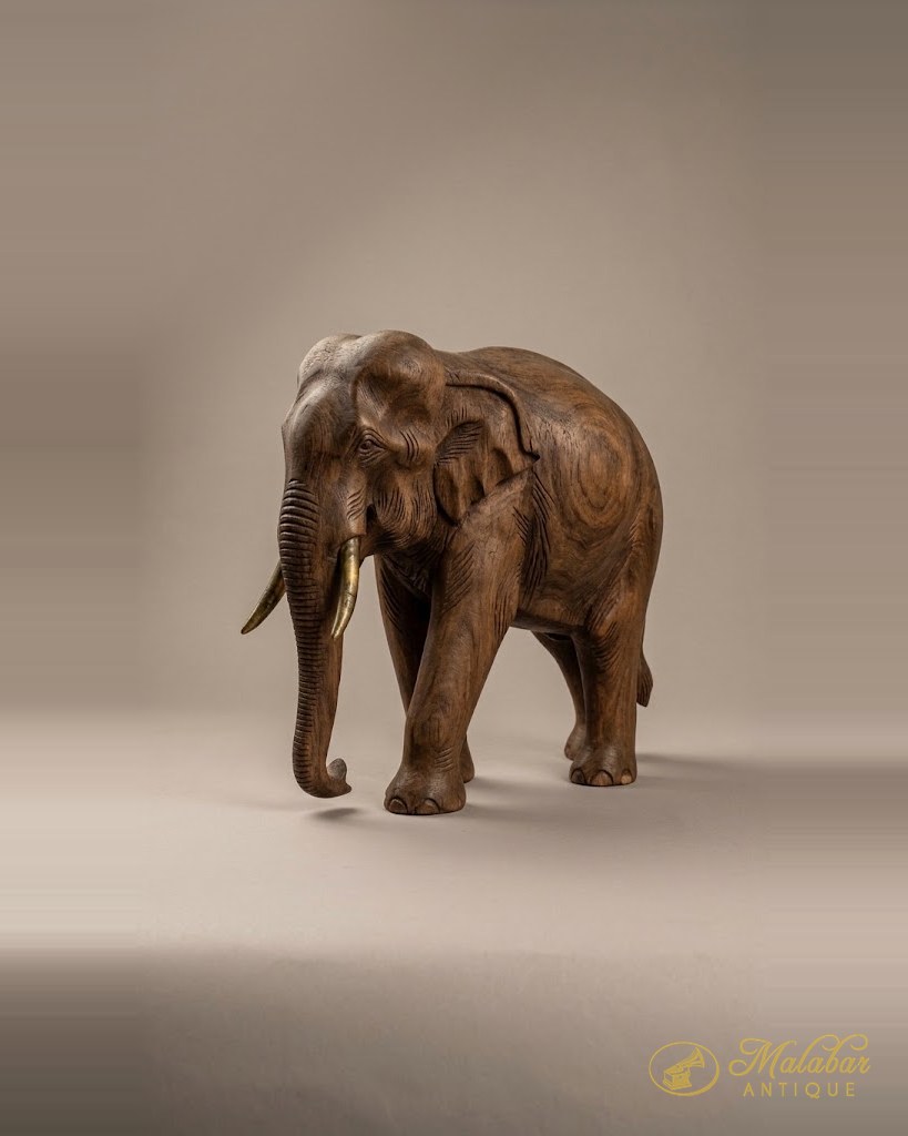 Standing elephant carved in hardwood with incised detail.