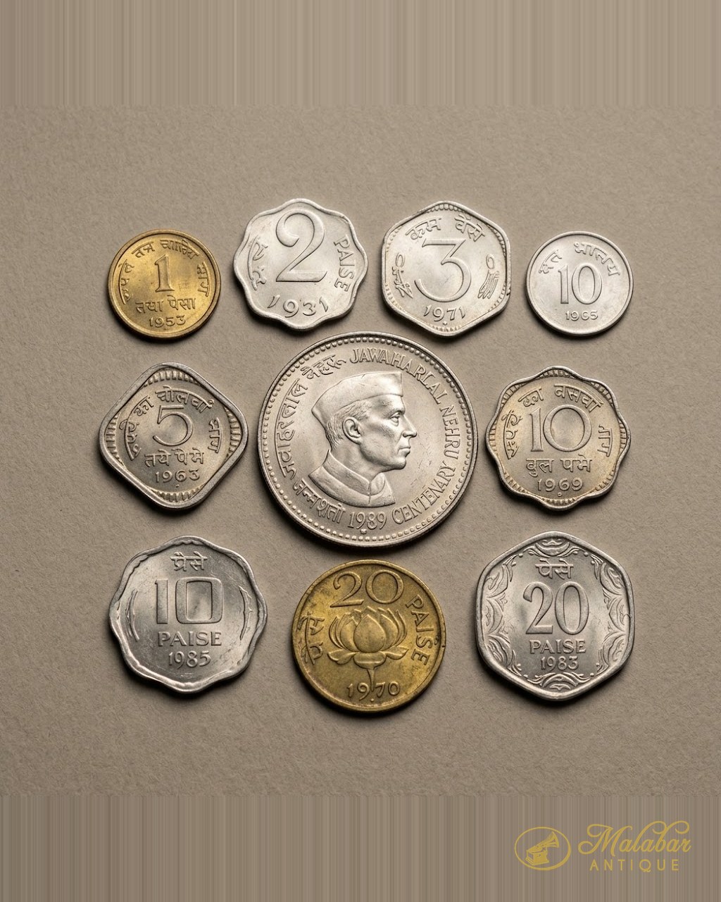 An arrangement of pre-decimal and early decimal Indian coins.