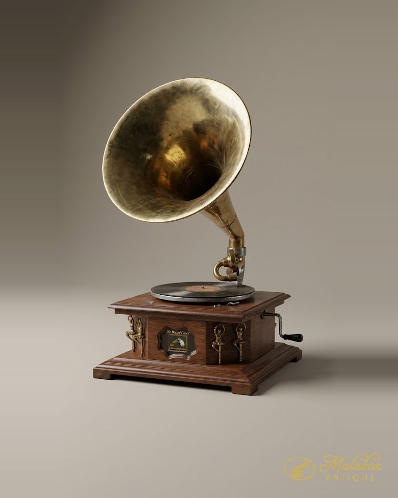 Wind-up gramophone with a large brass horn, turntable and record, in a square wooden case with brass mounts and a side crank.