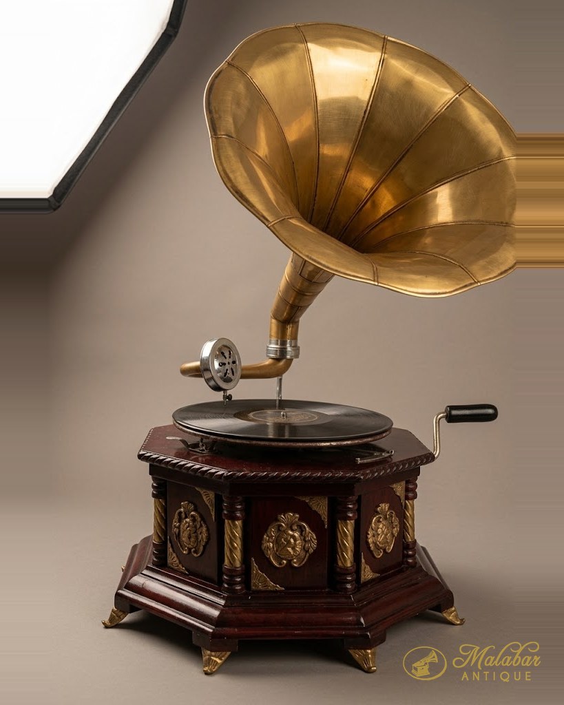 Wind-up gramophone with a fluted brass horn on a carved octagonal case.