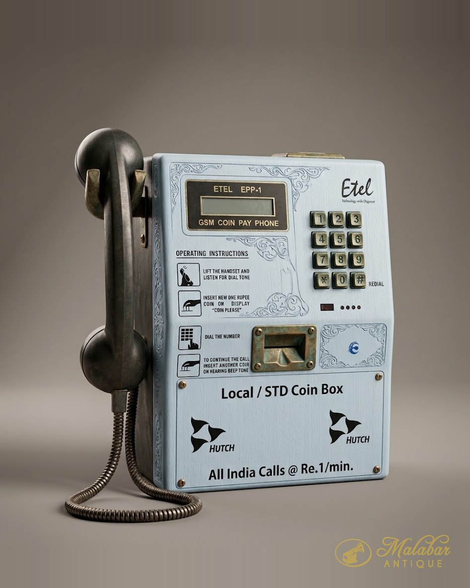 Wall-mounted coin payphone with a keypad and metal handset.