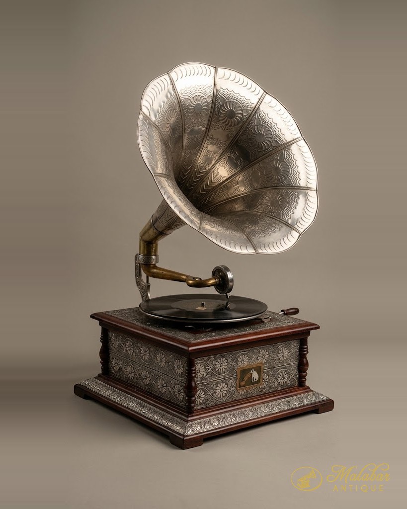 Gramophone with a large fluted metal horn on a decorated case.