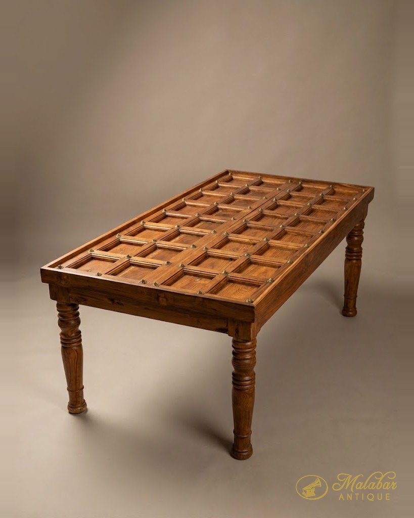 Low table made from a panelled door, the grid top set on turned legs.