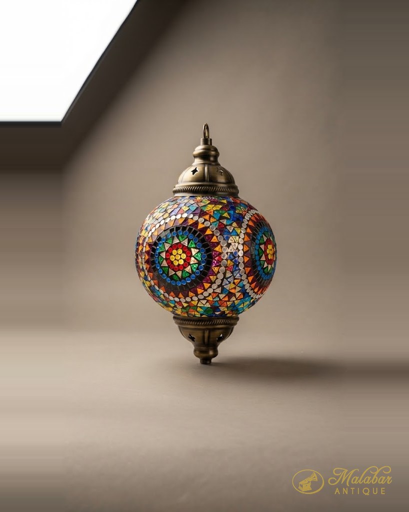 Spherical hanging lamp set with coloured glass mosaic in a floral pattern.